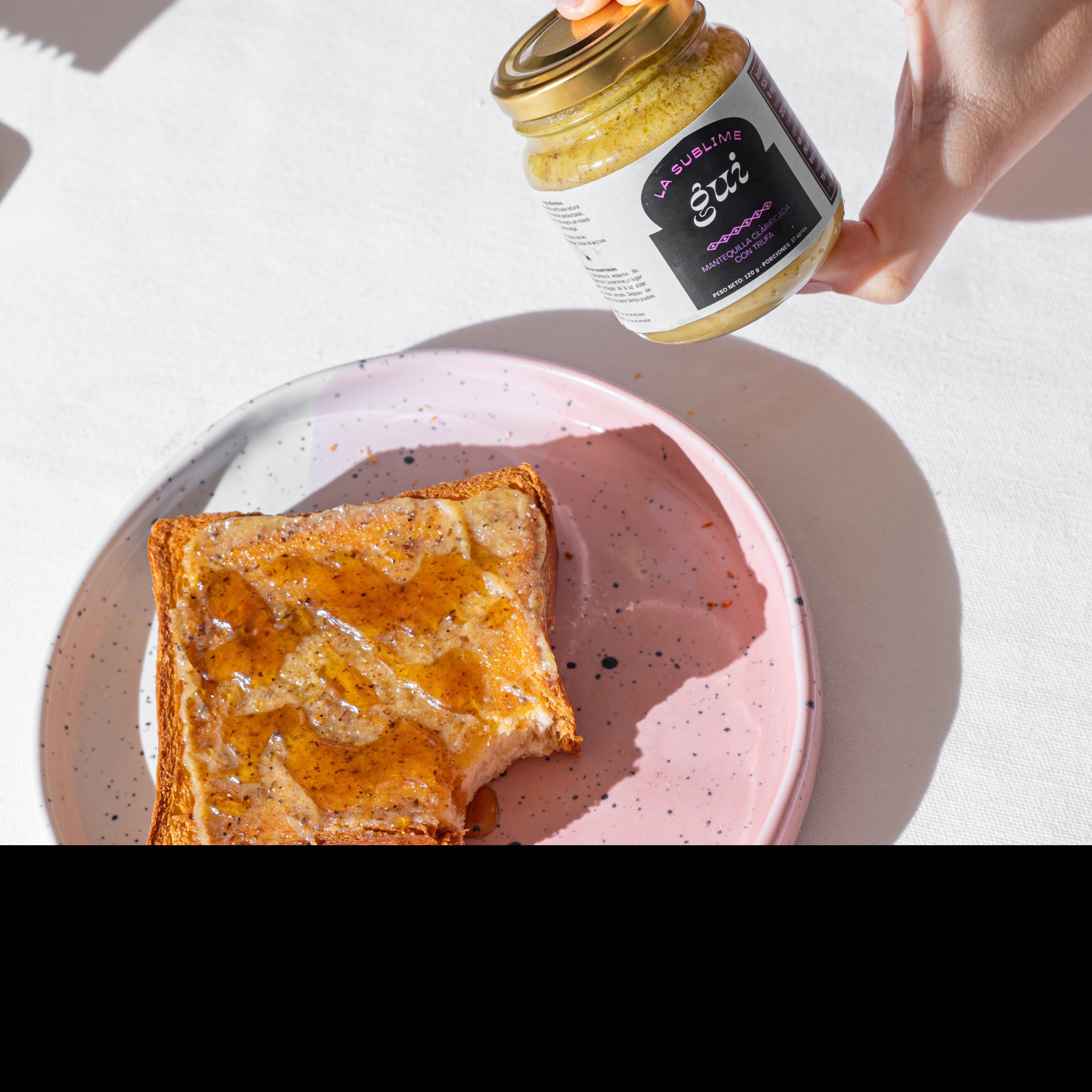 Tostada con ghee La Sublime, en plato rosa con luz solar